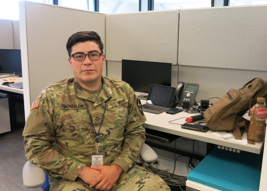 caption: Washington National Guard Pfc. Dominic Gonzales worked as a contact tracer at the state Department of Health in Tumwater in May.
