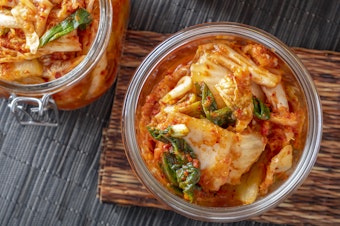 caption: Korean kimchi, made of salted and fermented vegetables, contains microbes that contribute to its distinctive taste.