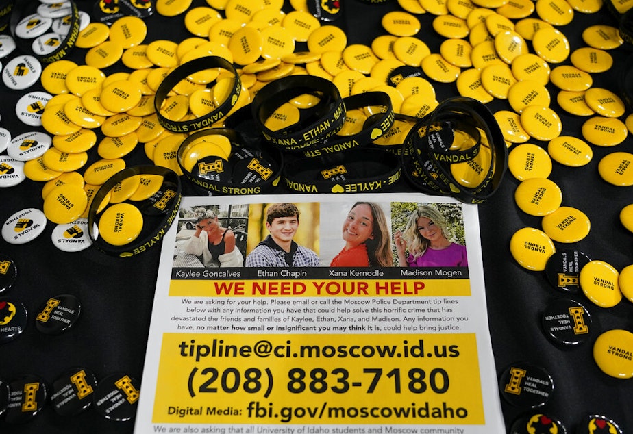 caption: A flyer seeking information about the killings of four University of Idaho students who were found dead is displayed on a table along with buttons and bracelets on Nov. 30, 2022, during a vigil in memory of the victims in Moscow, Idaho. A suspect in the killings of four University of Idaho students was arrested in eastern Pennsylvania, a law enforcement official said Friday, Dec. 30. 