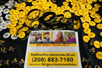 caption: A flyer seeking information about the killings of four University of Idaho students who were found dead is displayed on a table along with buttons and bracelets on Nov. 30, 2022, during a vigil in memory of the victims in Moscow, Idaho. A suspect in the killings of four University of Idaho students was arrested in eastern Pennsylvania, a law enforcement official said Friday, Dec. 30. 