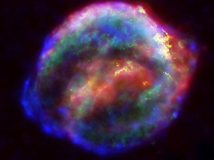 caption: Scientists believe some heavy elements are forged when a massive star goes through its death throes and explodes as a supernova. Here, the supernova Cassiopeia A was captured in a false-color image from NASA.