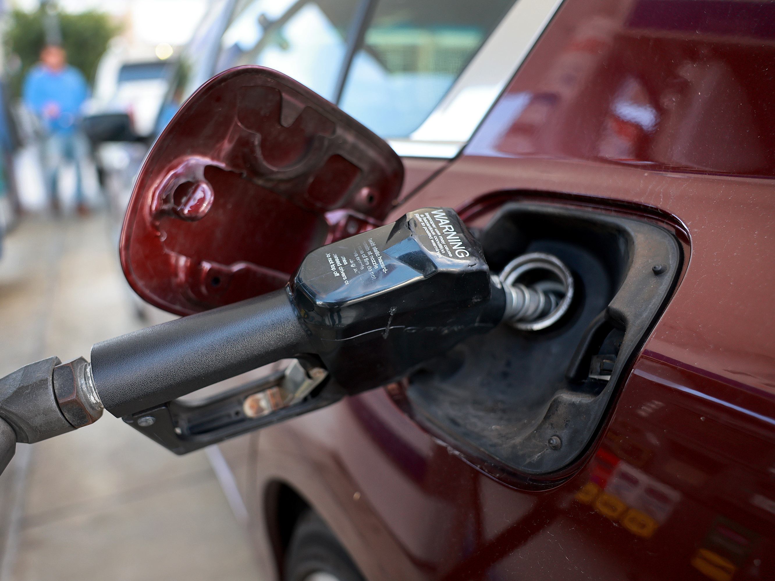 caption: Gas is pumped into a vehicle at a gas station in Miami on Jan. 23, 2023. A rise in gas prices caused inflation to increase in January when compared to December. Gas prices remain volatile, making the outlook for inflation more uncertain.