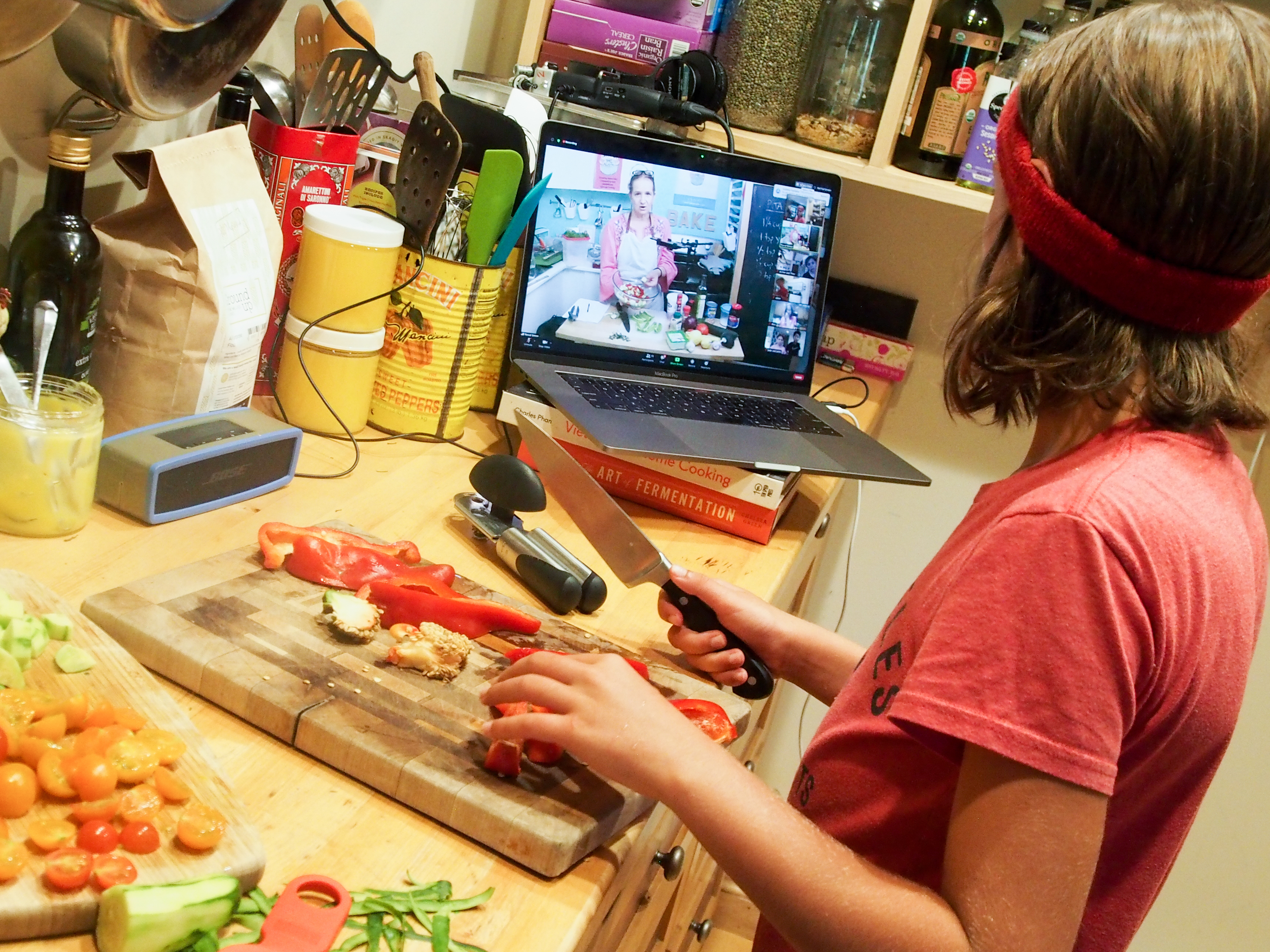 caption: Wiley James, 10, prepares a meal as part of an online cooking camp run by a chef in Austin, Texas.