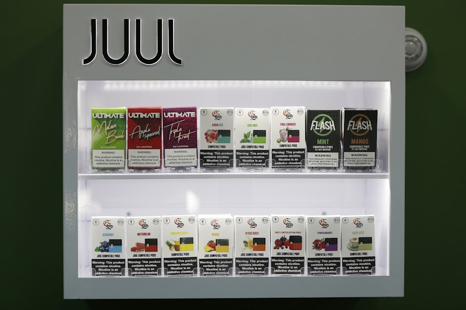 caption: FILE - In this Sept. 3, 2019, file photo, electronic cigarette pods are displayed for sale at a shop, in Biddeford, Maine. Today Juul and hundreds of smaller companies are at the center of a political backlash that threatens to sweep e-cigarettes from stores shelves nationwide as politicians scramble to address two separate public health crises tied to vaping: underage use among teenagers and a mysterious and sometimes fatal lung ailment that affected more than a thousand people.