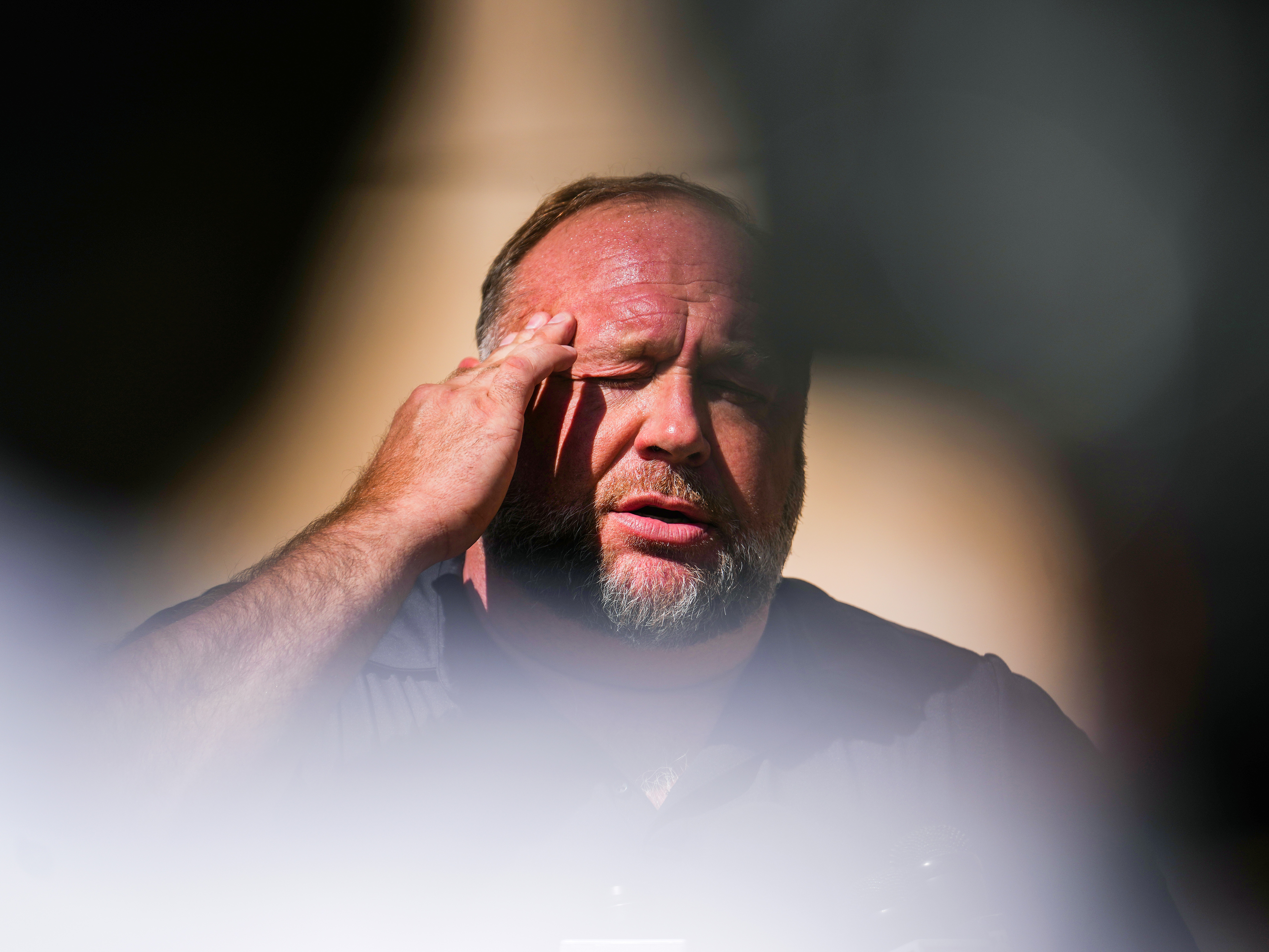 caption: After The Onion was named the winning bidder for Alex Jones' assets at a bankruptcy auction last month, the losing bidder tried to stop the sale, saying the process was rigged and "fatally flawed."