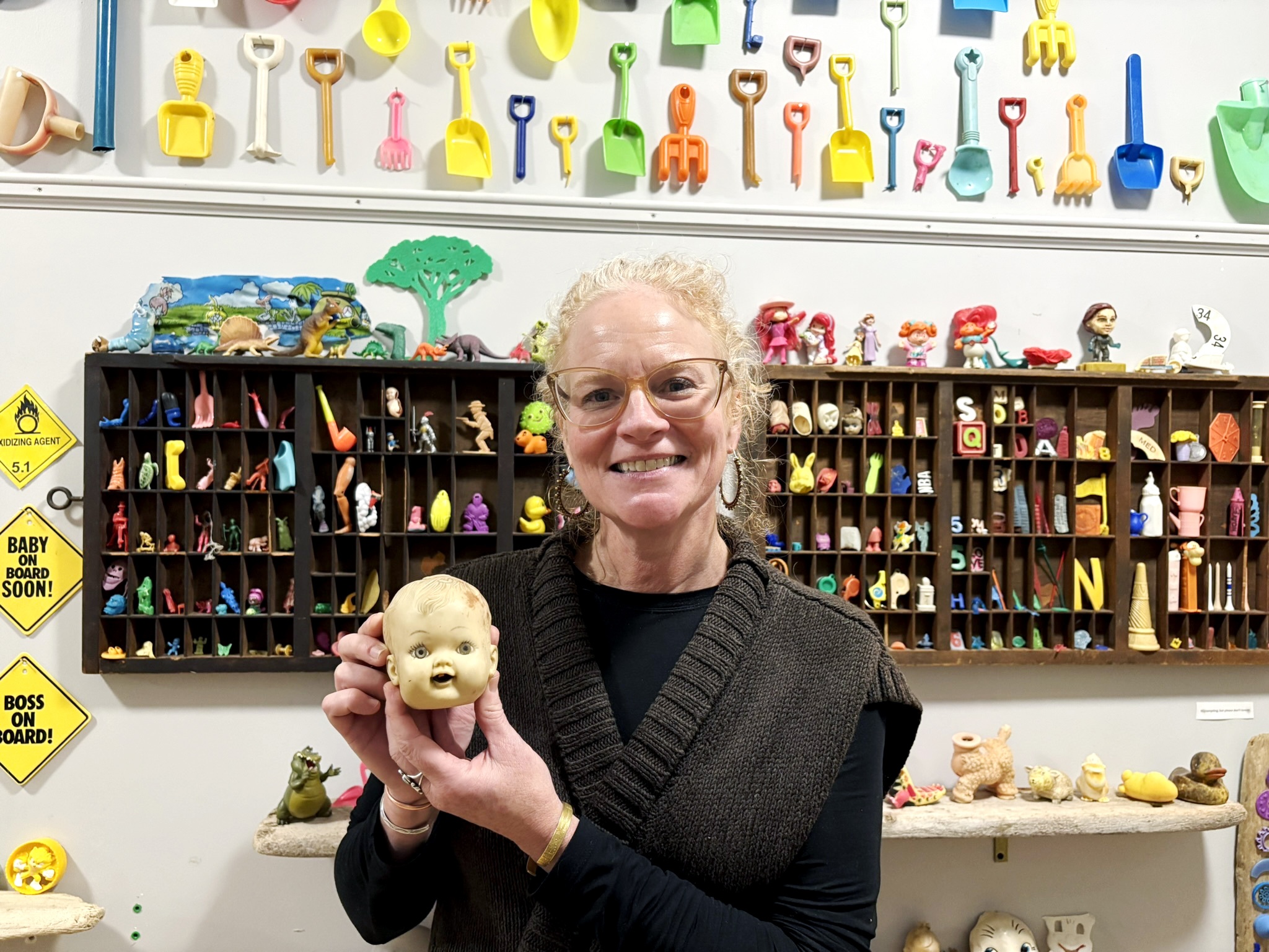 caption: Corinn Flaherty holds the first doll head she found washed ashore in 2015. It propelled her "descent down the flotsam rabbit hole" and was her inspiration for the Plum Island Museum of Lost Toys &amp; Curiosities.