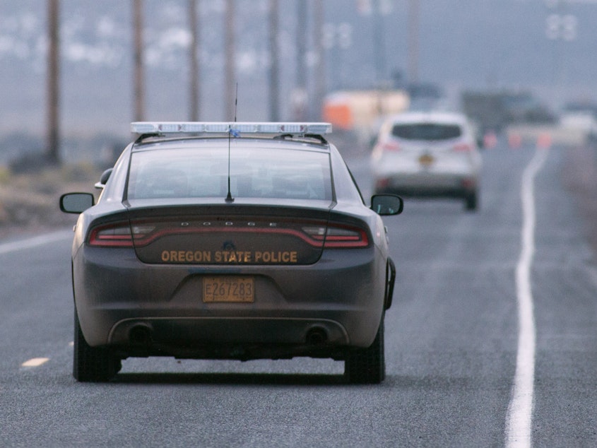 caption: An Oregon State Police cruiser approaches a checkpoint in the Malheur National Wildlife Refuge on January 28, 2016 near Burns, Oregon.
