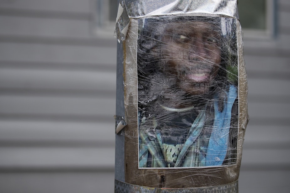 caption: An image of Manuel Ellis is taped to a utility pole on Thursday, June 4, 2020, near the intersection of Ainsworth Avenue South and 96th Street South in Tacoma. Ellis was killed by police on March 3rd.