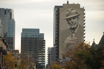 caption: A memorial mural of musician Leonard Cohen in downtown Montreal.