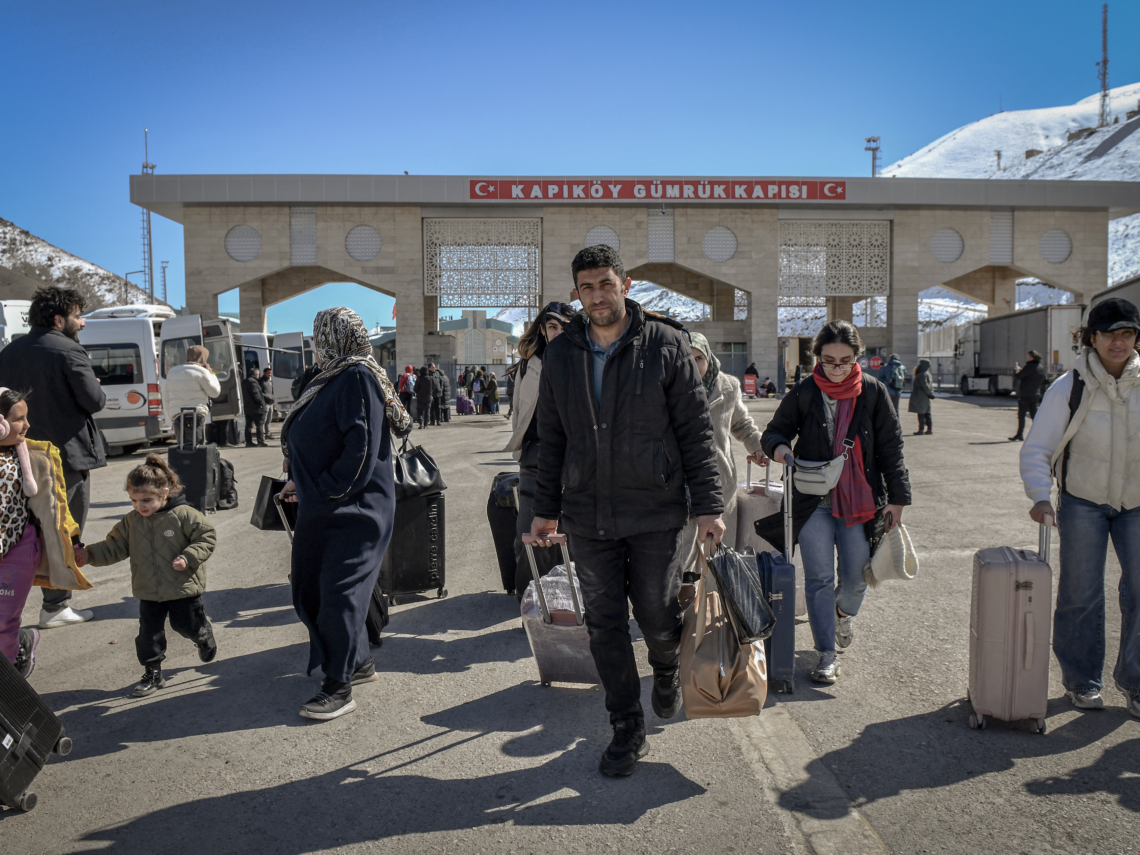 caption: Iranian nationals arrive in Turkey after passing through the Razi-Kapiköy border crossing in Van, northeastern Turkey, on Tuesday, a day after Turkey and Iran mutually suspended day-trip crossings at their border as Israeli-U.S. strikes continued to pound the Islamic Republic.