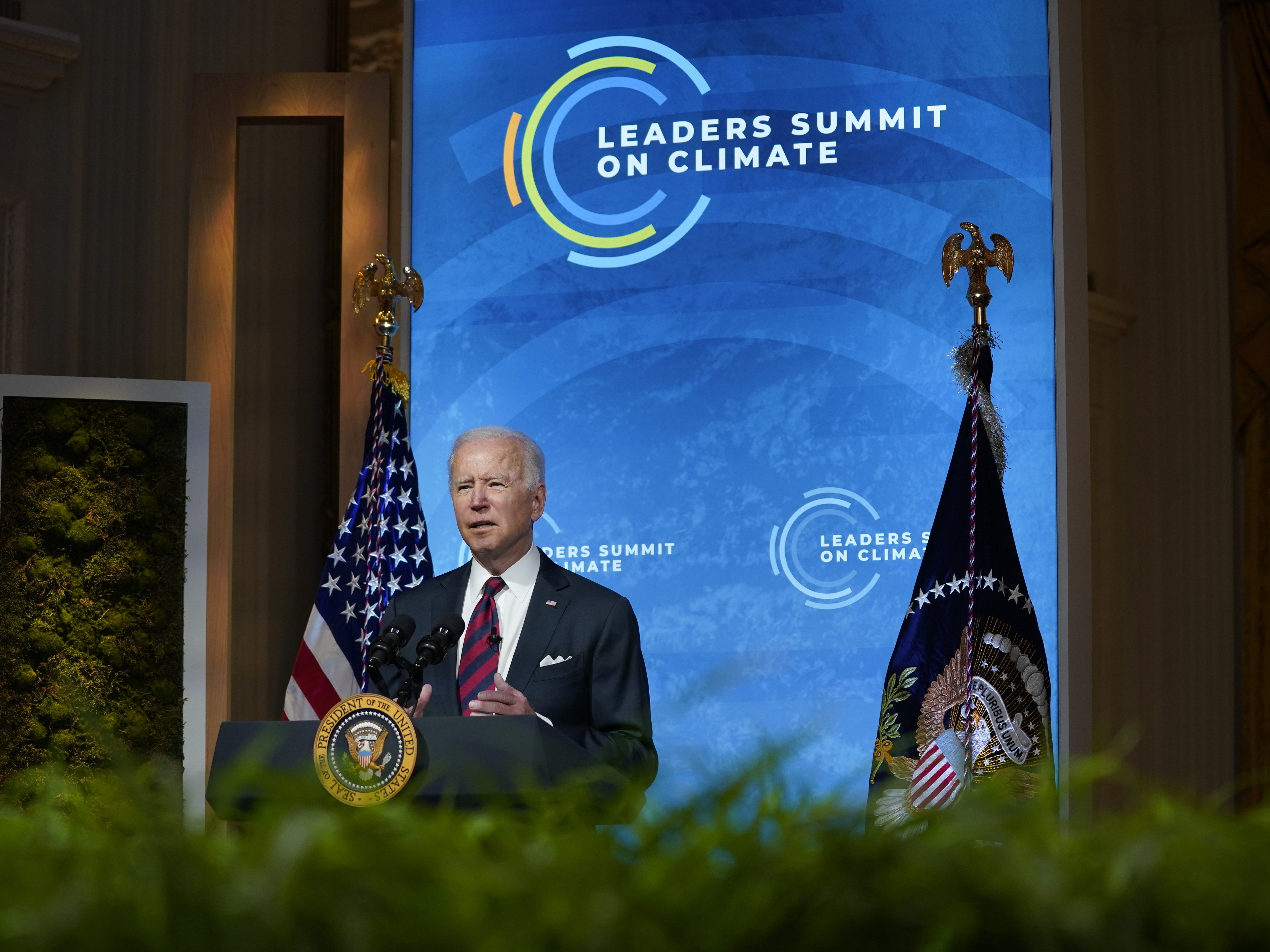 caption: President Biden delivers opening remarks to the virtual Leaders Summit on Climate from the East Room of the White House on Thursday.