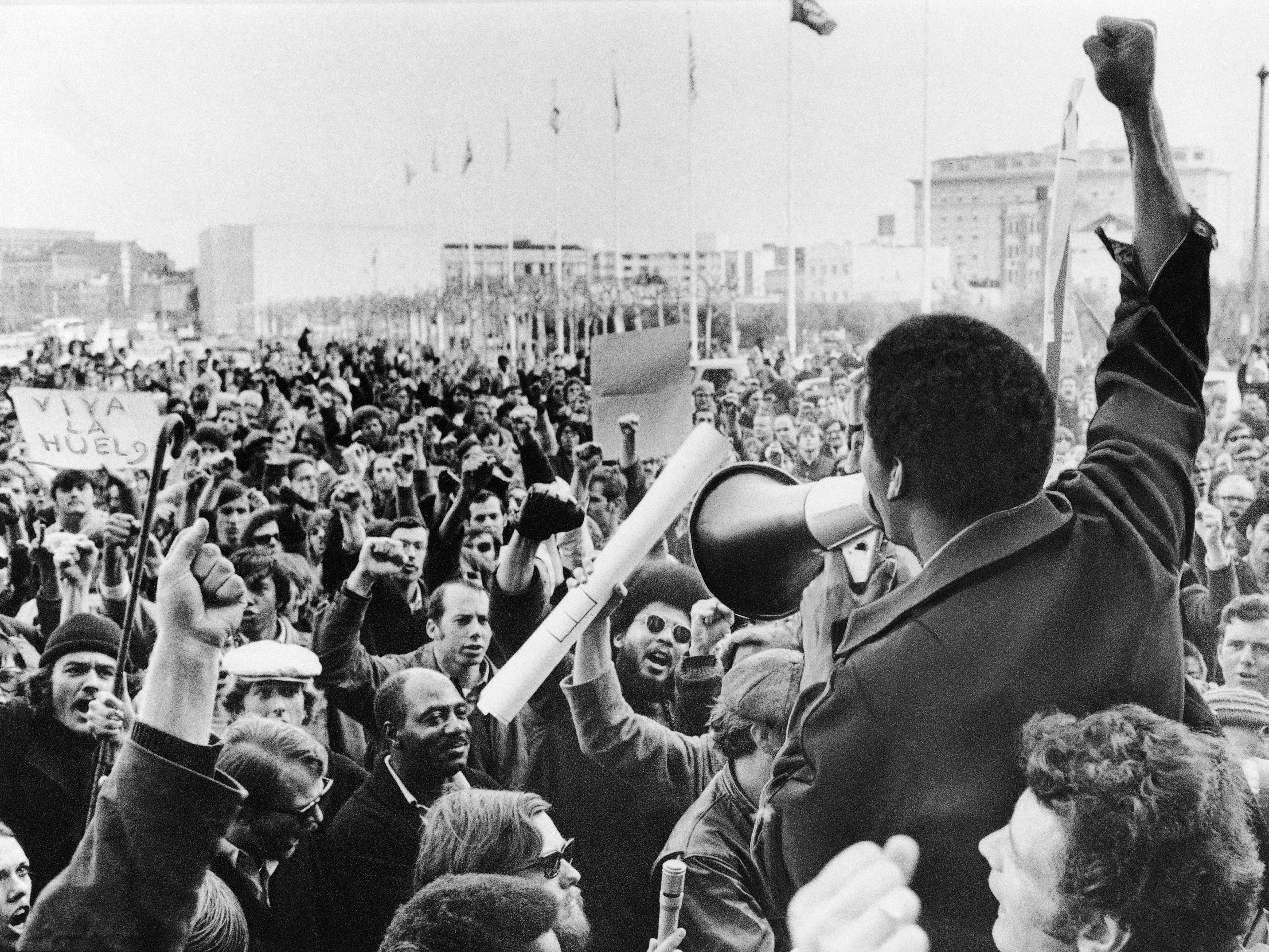 caption: A Black Students Union leader in front of a crowd of demonstrators at San Francisco State College in December 1968.
