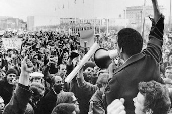 caption: A Black Students Union leader in front of a crowd of demonstrators at San Francisco State College in December 1968.