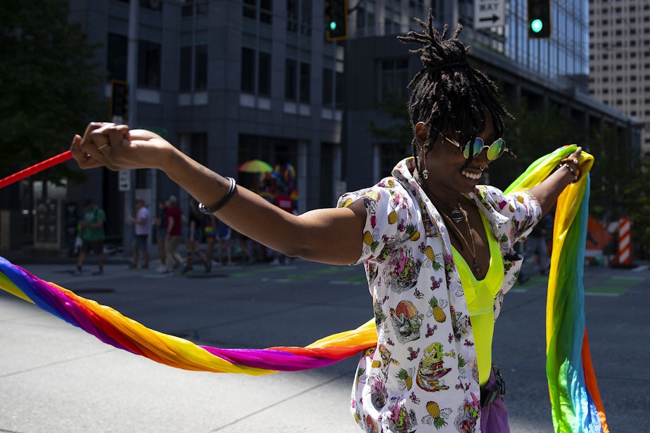caption: Von Tele, 33, roller-skates while twirling rainbow fabric during Seattle’s Pride Parade on Sunday, June 25, 2023, in downtown Seattle. 