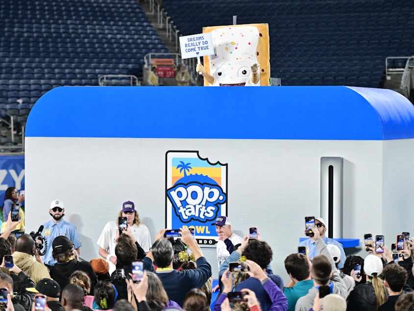 caption: The Pop-Tarts mascot is lowered into a toaster following the 2023 Pop-Tarts Bowl between the Kansas State Wildcats and the NC State Wolfpack at Camping World Stadium on Thursday in Orlando, Fla.