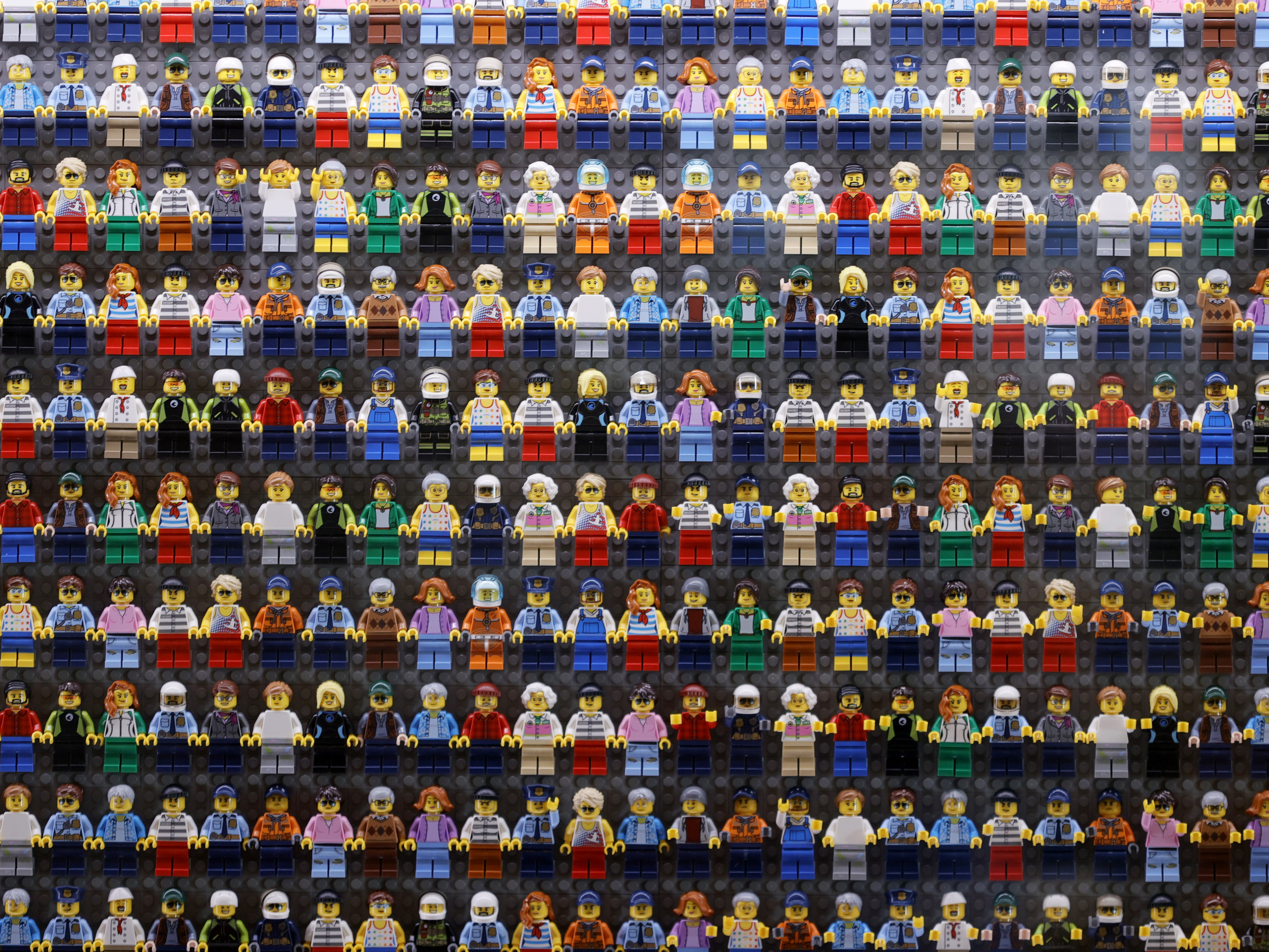 caption: A wall of LEGO minifigures is encased inside the lobby of the LEGOLAND New York Hotel, pictured on Aug. 6 2021 in Goshen, New York. The Danish company is pledging to remove harmful stereotypes from its products and marketing.