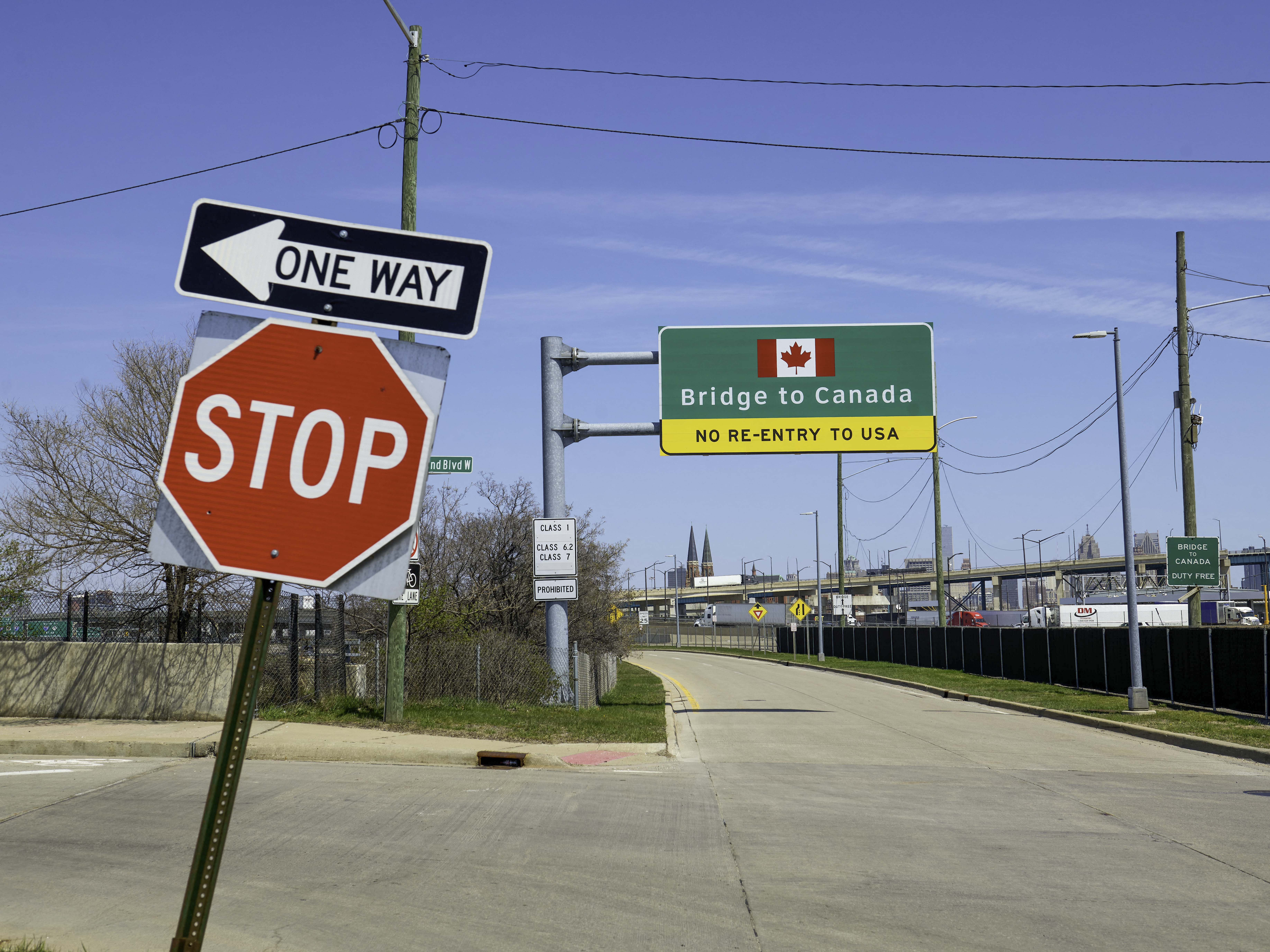 caption: Signs notify drivers at the U.S.-Canada Ambassador Bridge border crossing in Detroit, Michigan.