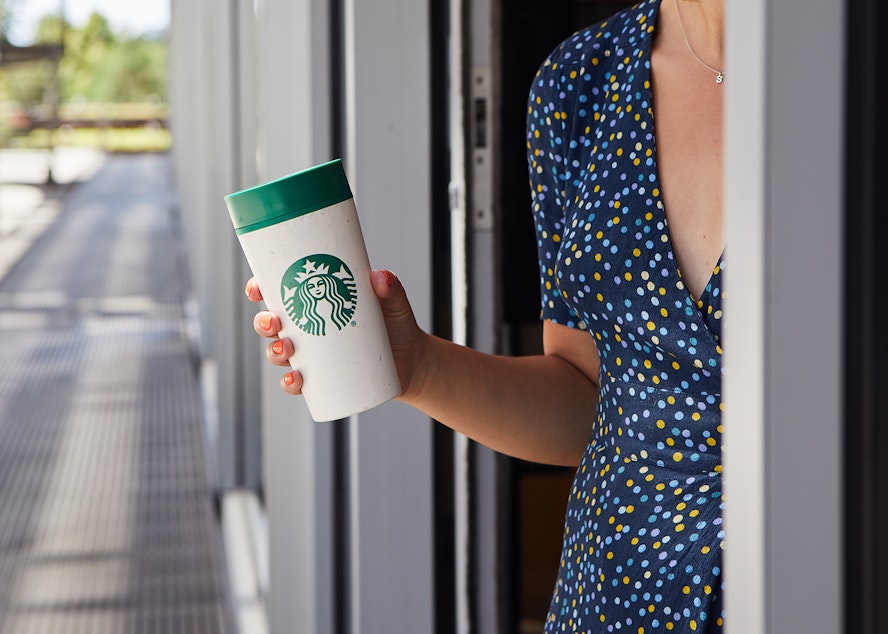 caption: Starbucks plans to offer borrow-a-cup programs in more stores by 2025.
