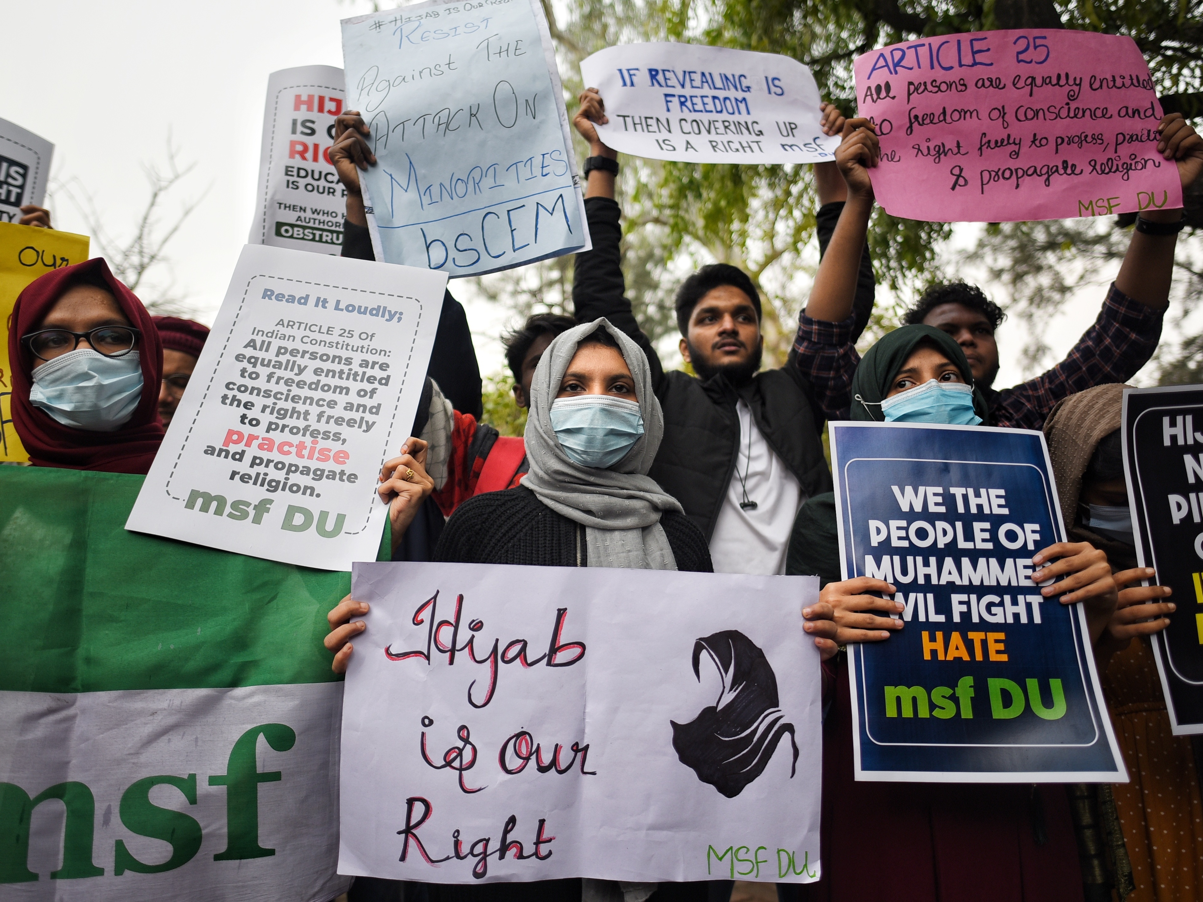 caption: Members of the All India Muslim Students Federation protest at Delhi University against the hijab ban in educational institutions, on Feb. 8 in New Delhi, India.