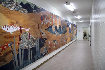 caption: A mural by Haruka Ostley called 'Journey to Peace' spans a hallway on Wednesday, February 5, 2020, during a media tour of the new Clark Children and Family Justice Center on Alder Street in Seattle.