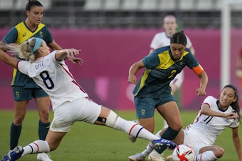 caption: Australia's Sam Kerr and Julie Ertz of the U.S. battle for the ball during a women's soccer match at the Tokyo Olympics on Tuesday.