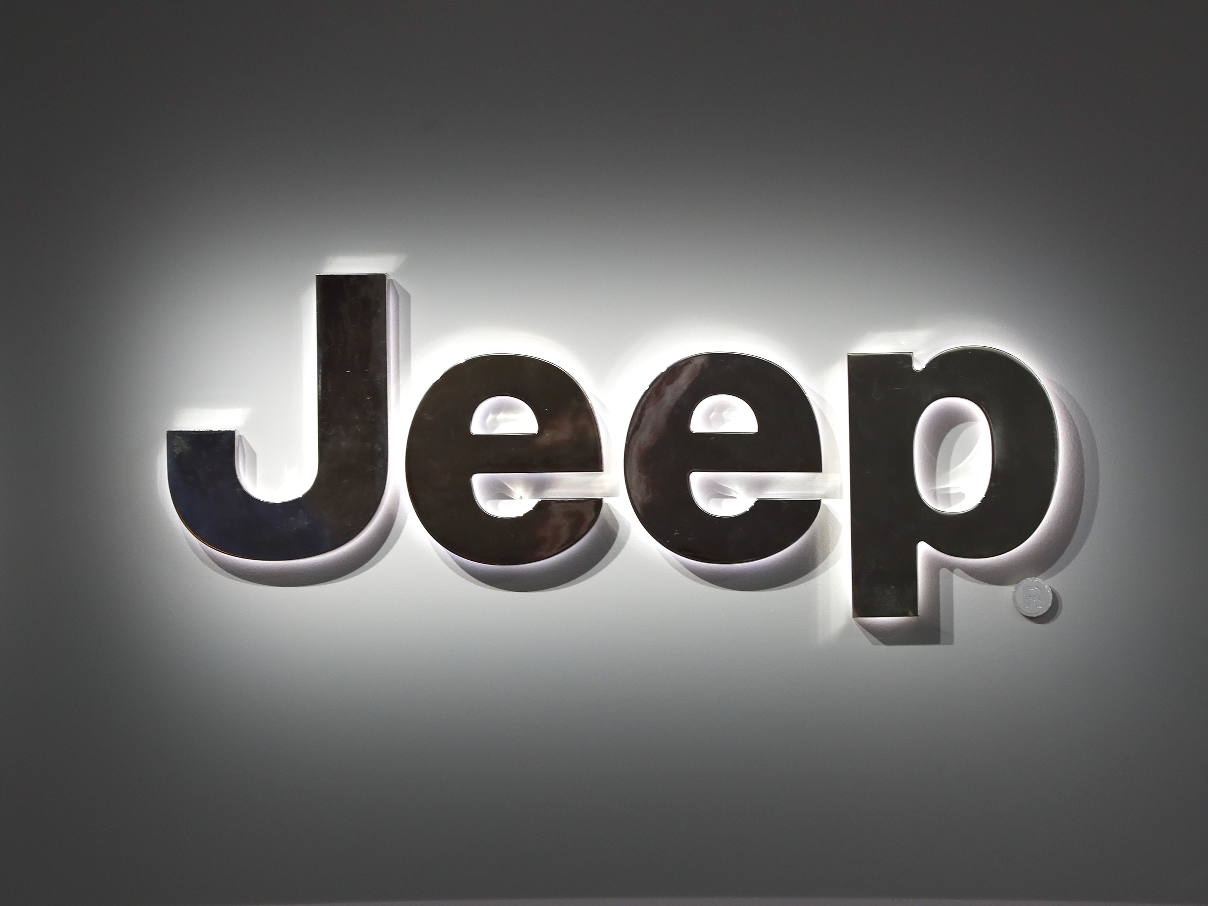 caption: A Jeep logo is displayed at the North American International Auto Show in Detroit on Jan. 14, 2019. Jeep is recalling more than 194,000 plug-in hybrid SUVs worldwide because they can catch fire with the ignition turned off.