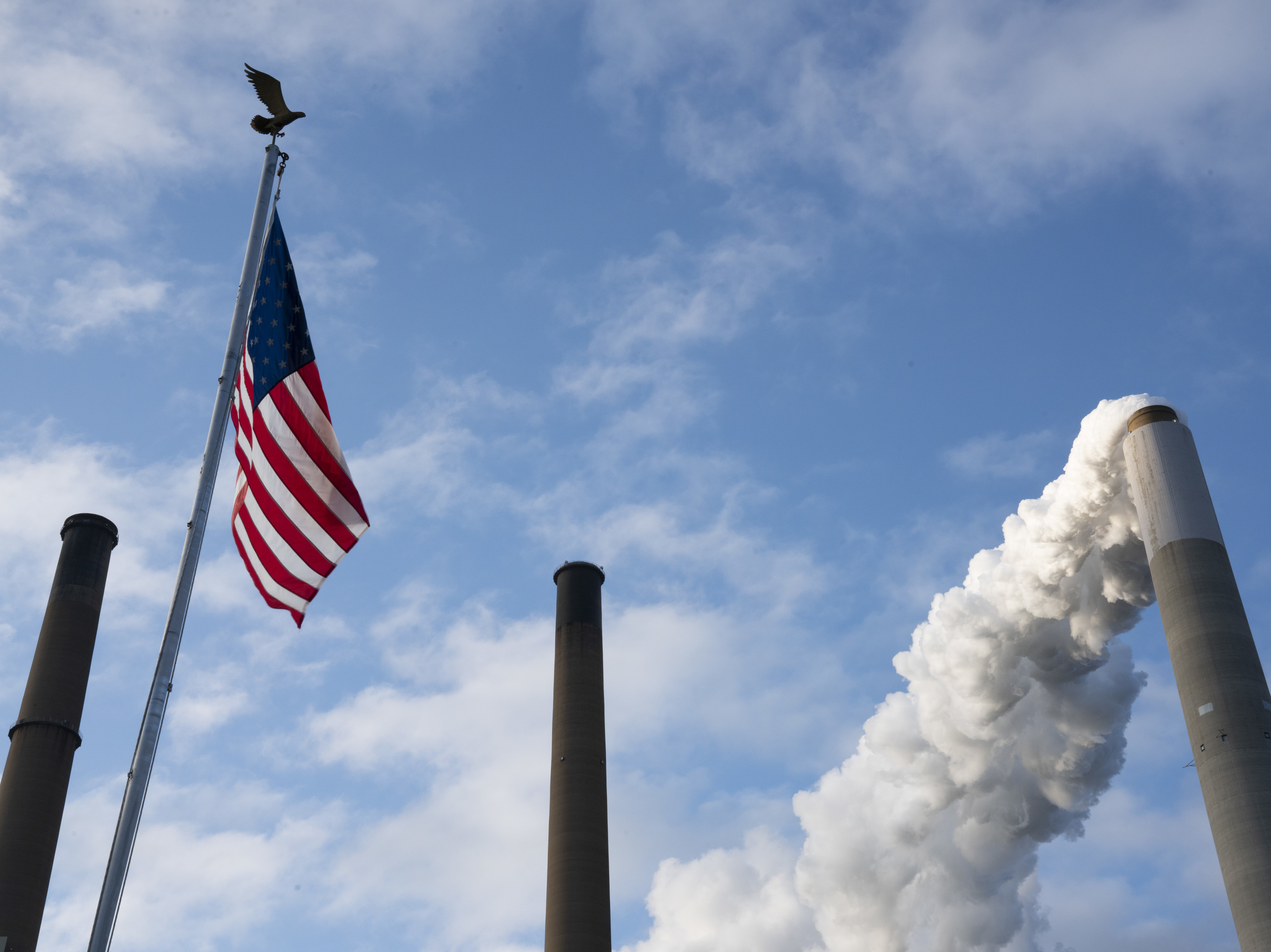 caption: Emissions rise from a smokestack in Ohio.