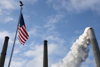 caption: Emissions rise from a smokestack in Ohio.