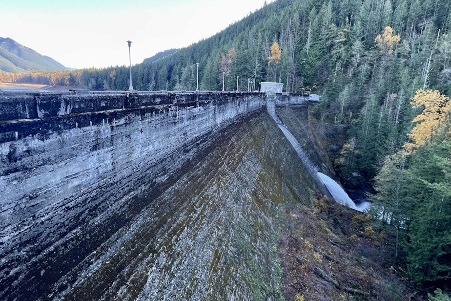 caption: Water spills from the Masonry Dam on the Cedar River in the central Washington Cascades on Nov. 17, 2023.