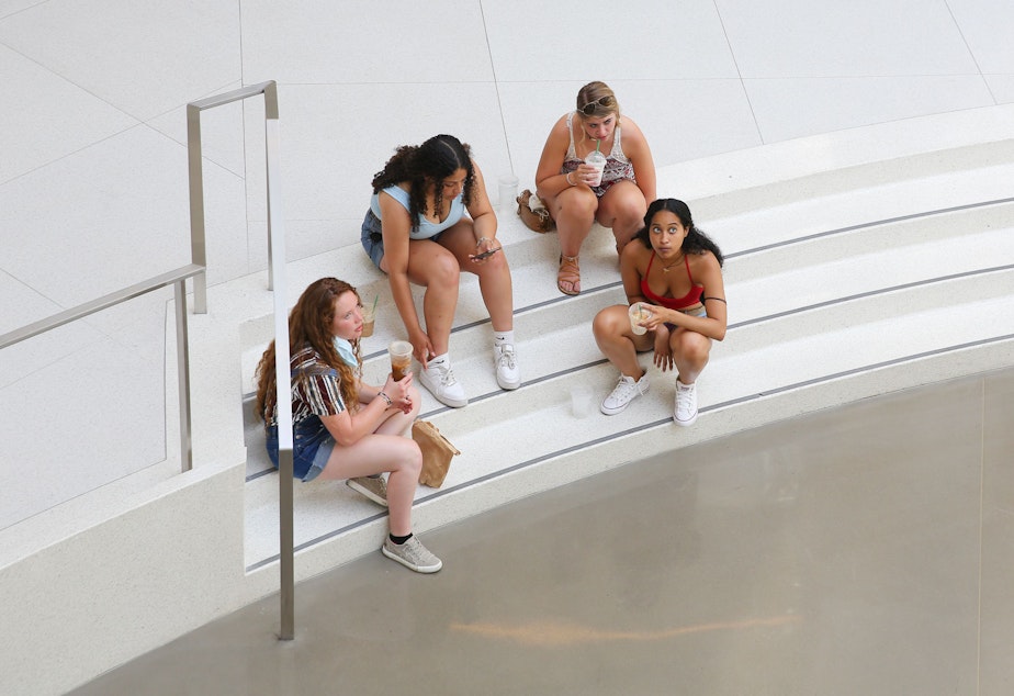 caption: From left, Shannon Kelly, Briana Chappell, Ashley Schmidt and Erica McDowell, all friends from college spending a weekend together, cool off inside the air conditioned Pacific Place Mall on Sunday as temperatures reached 104, according to the National Weather Service. Seattle dealt with record breaking temperatures all weekend and into Monday.
