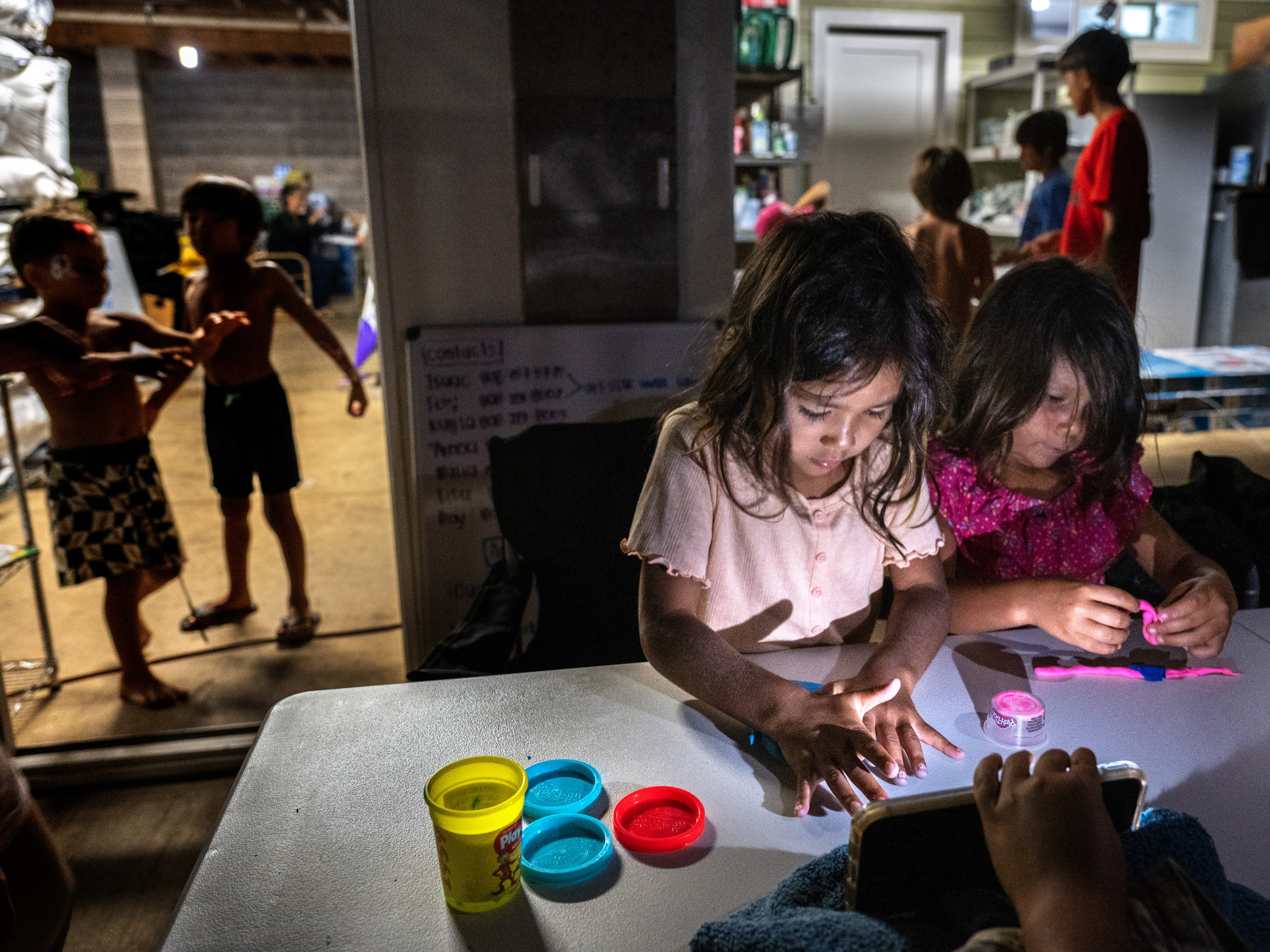 caption: Five-year-old cousins Layla and Mila Cabanilla Okano are among the many children staying with members of their extended family at one property on Maui in the wake of the wildfires.