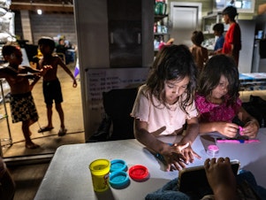 caption: Five-year-old cousins Layla and Mila Cabanilla Okano are among the many children staying with members of their extended family at one property on Maui in the wake of the wildfires.