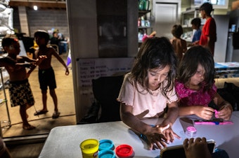 caption: Five-year-old cousins Layla and Mila Cabanilla Okano are among the many children staying with members of their extended family at one property on Maui in the wake of the wildfires.