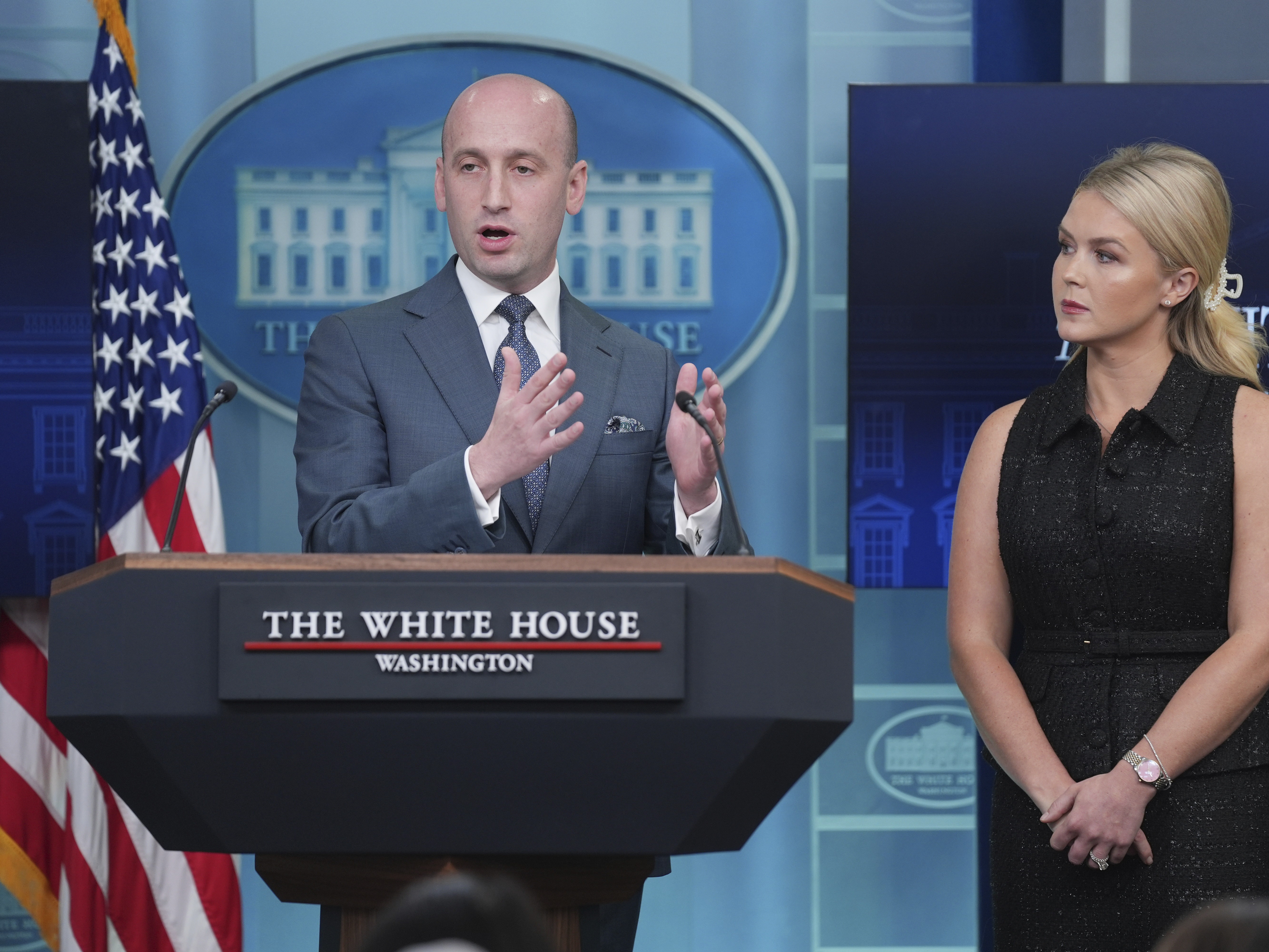 caption: White House Deputy Chief of Staff Stephen Miller called gender-affirming care for children "barbaric" at a press conference on Thursday. Press secretary Karoline Leavitt looks on.