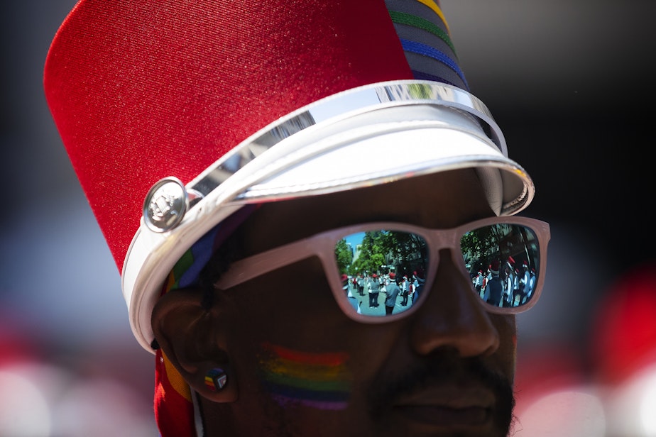 caption: A trumpet player with the Rainbow City Band marches in Seattle’s Pride Parade on Sunday, June 25, 2023, in downtown Seattle. 