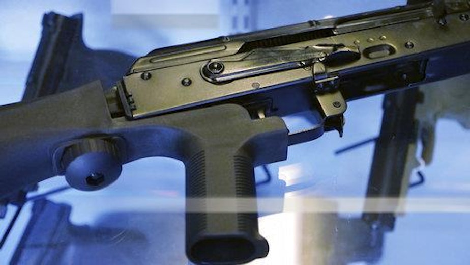 caption: In this Oct. 4, 2017, photo, a device called a "bump stock" is attached to a semi-automatic rifle at the Gun Vault store and shooting range in South Jordan, Utah. 18355688918754