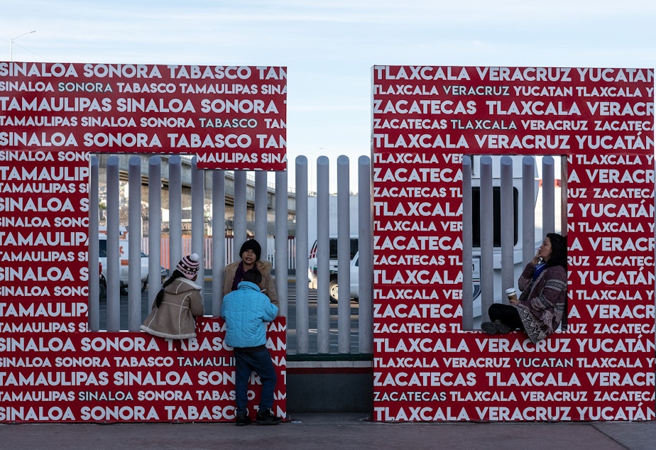 Migrants seeking an asylum appointment with U.S. Customs and Border Protection officers wait at El Chaparral port of entry in Tijuana.