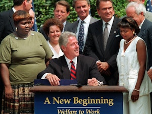 caption: Lillie Harden and Penelope Howard, two former welfare recipients, were invited guests to President Clinton's signing of the law that would place new requirements and restrictions on welfare.