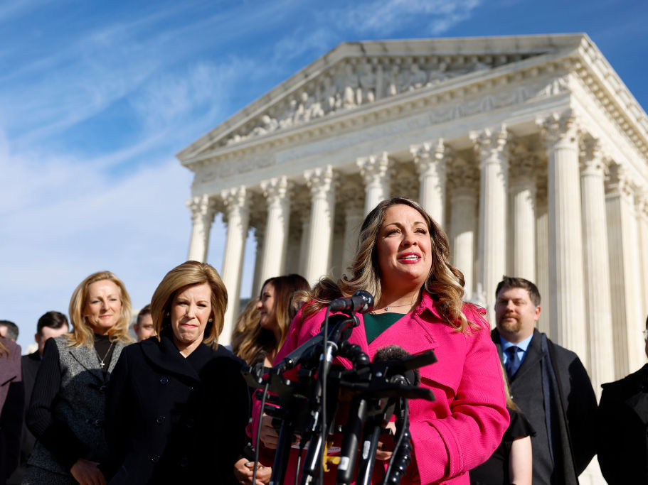 caption: Lorie Smith, the owner of 303 Creative, a website design company in Colorado, speaks Monday to reporters outside of the U.S. Supreme Court in Washington.