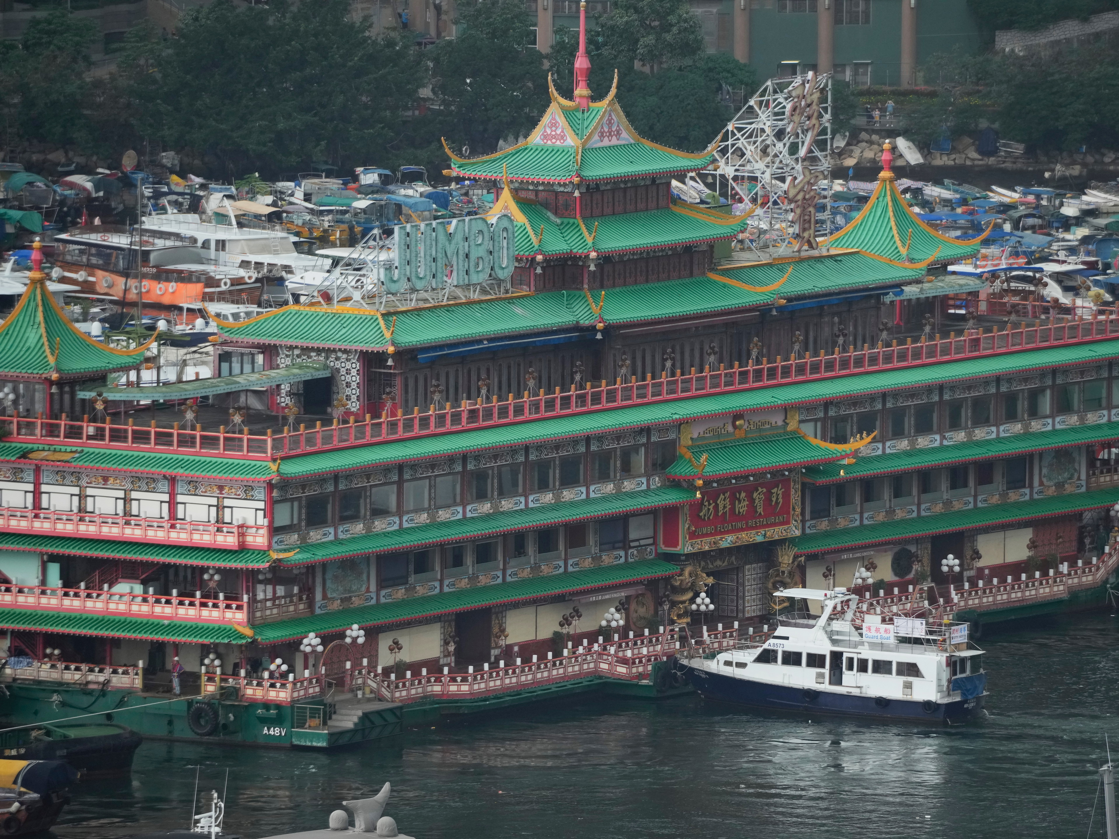 caption: Hong Kong's iconic Jumbo Floating Restaurant is towed away in Hong Kong on June 14. It capsized at sea less than a week later.