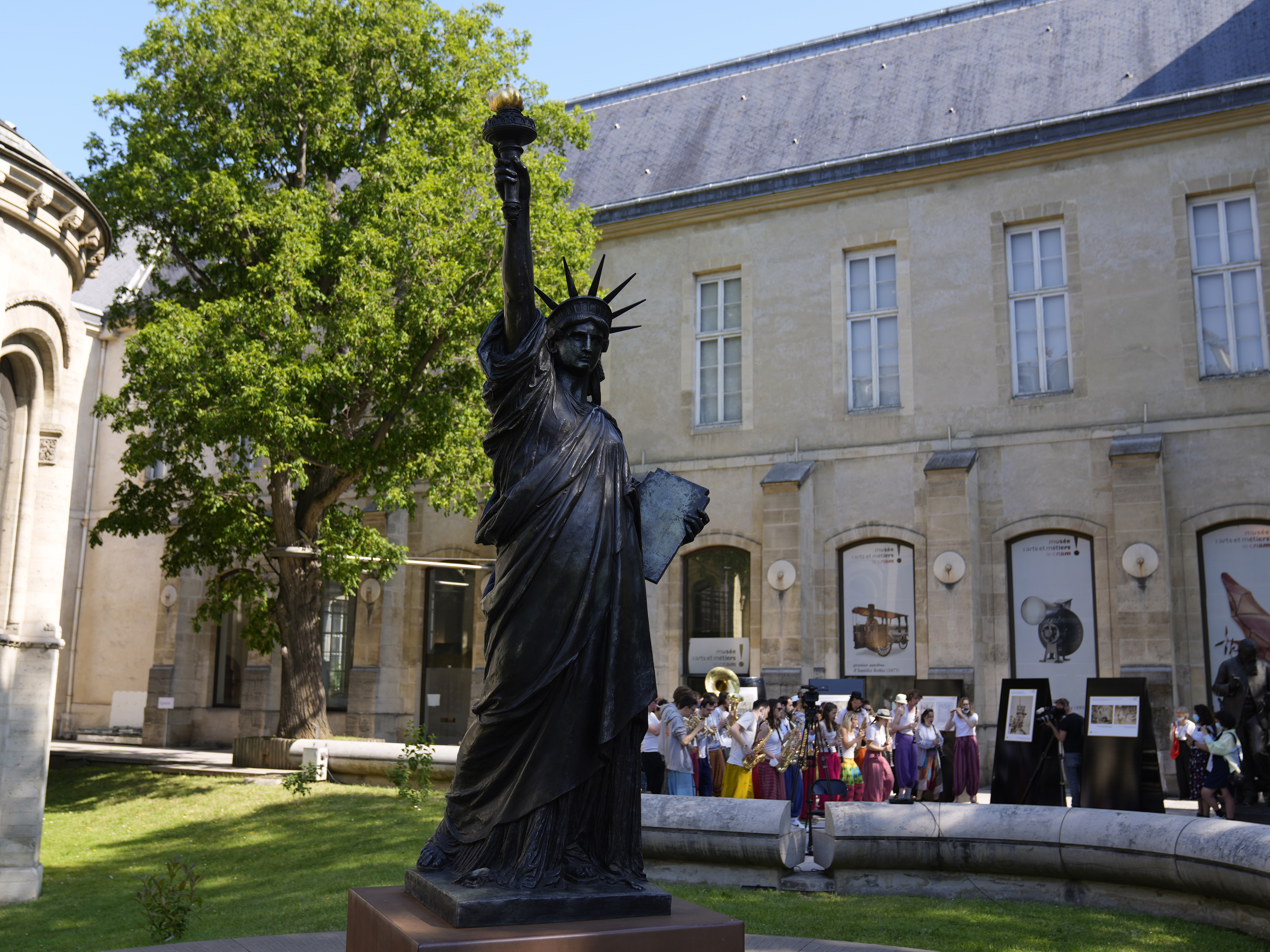 caption: A mini replica of the French-designed Statue of Liberty will reach the U.S. on July 1. Here, the statue awaits its move in Paris on Monday.