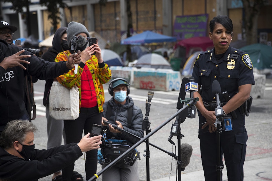caption: Seattle Police Chief Carmen Best stands in front of the Seattle Police Department's abandoned East Precinct building during a press conference on Monday, June 29, 2020, inside the Capitol Hill Organized Protest zone, CHOP, in Seattle. Earlier in the morning, a 16-year-old boy was killed and a 14-year-old boy was critically injured in a shooting.
