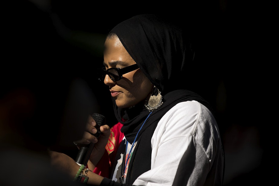 caption: Shugla Kakar, a founding member of Afghans of Seattle, leads a march of about 100 people standing in solidarity with Afghans on Saturday, August 28, 2021, near Westlake Park in Seattle. "What is happening in Afghanistan is devastating," said Kakar. "We're trying to amplify Afghan voices and experiences, and push for urgent action by our federal, state and local leaders to help evacuate those at grave risk in Afghanistan while also supporting the incoming Afghan refugees in our state."