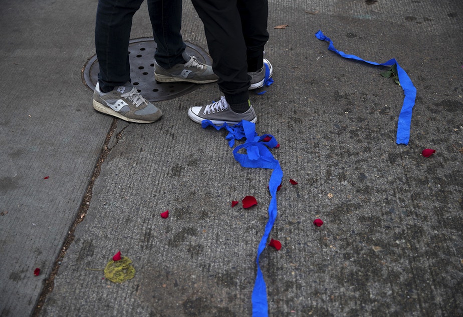 caption: Rose pedals and blue streamers are shown on the ground during an impromptu celebration after Joe Biden was officially named the president elect on Saturday, November 7, 2020, at the intersection of 10th Avenue and East Pine Street in Seattle.