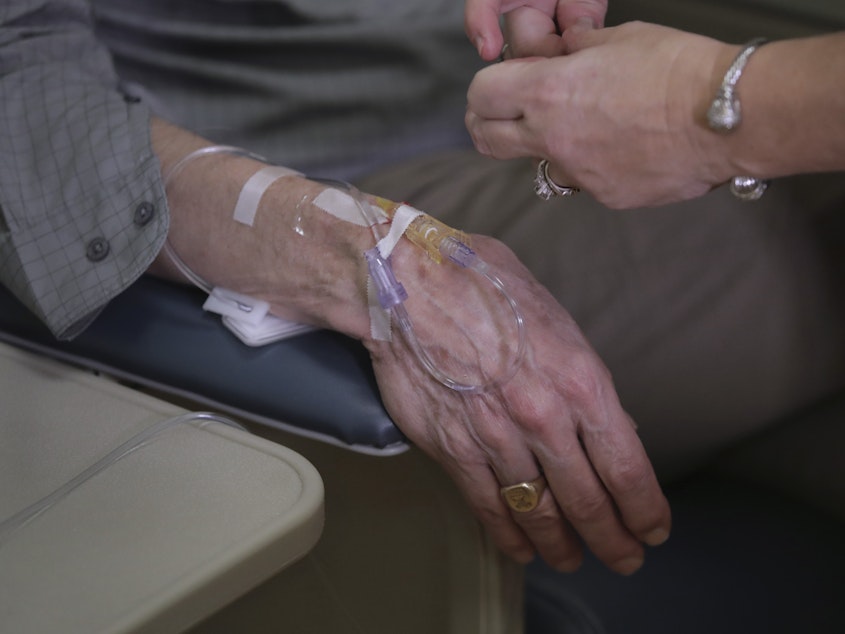 caption: As part of clinical study, Charles Flagg, a patient with Alzheimer's disease, received an infusion of aducanumab at Butler Hospital in Providence, R.I., in late 2019.