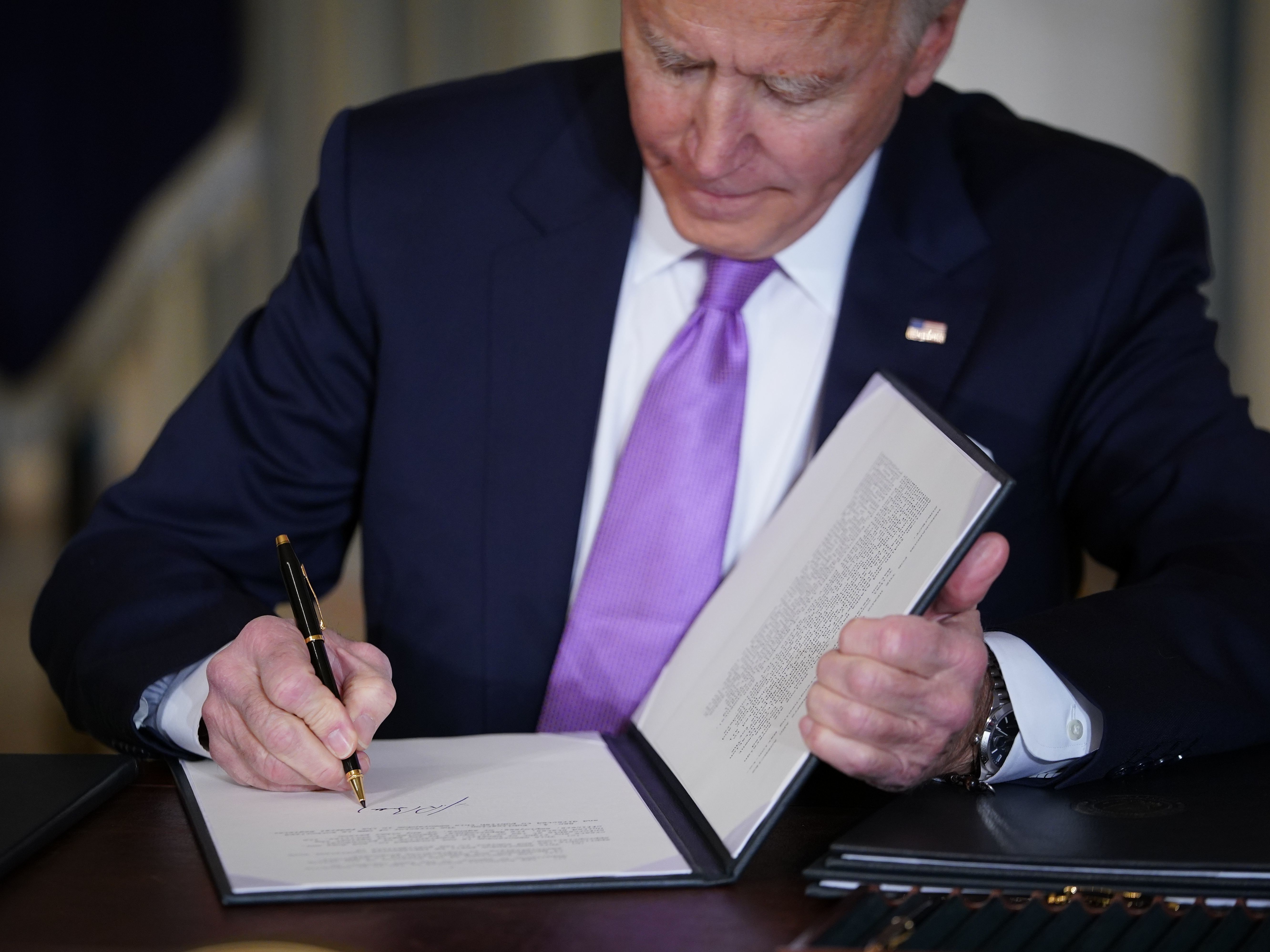 caption: On his first day in office, President Biden signed an executive order requiring his appointees to take a stringent ethics pledge.
