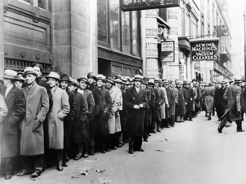 caption: Unemployed people wait outside the state Labor Bureau in New York City in 1933. The current economic crisis has drawn comparisons to the Great Depression, but experts say this downturn should be shorter.