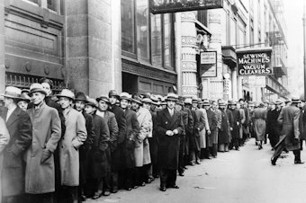 caption: Unemployed people wait outside the state Labor Bureau in New York City in 1933. The current economic crisis has drawn comparisons to the Great Depression, but experts say this downturn should be shorter.