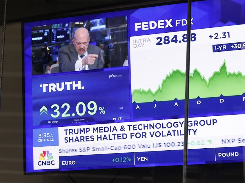 caption: News of Trump Media & Technology Group public trading is seen on television screens at the Nasdaq Marketplace on March 26, 2024 in New York City. At one point, the company was valued at over $9 billion after trading began.