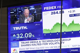 caption: News of Trump Media & Technology Group public trading is seen on television screens at the Nasdaq Marketplace on March 26, 2024 in New York City. At one point, the company was valued at over $9 billion after trading began.